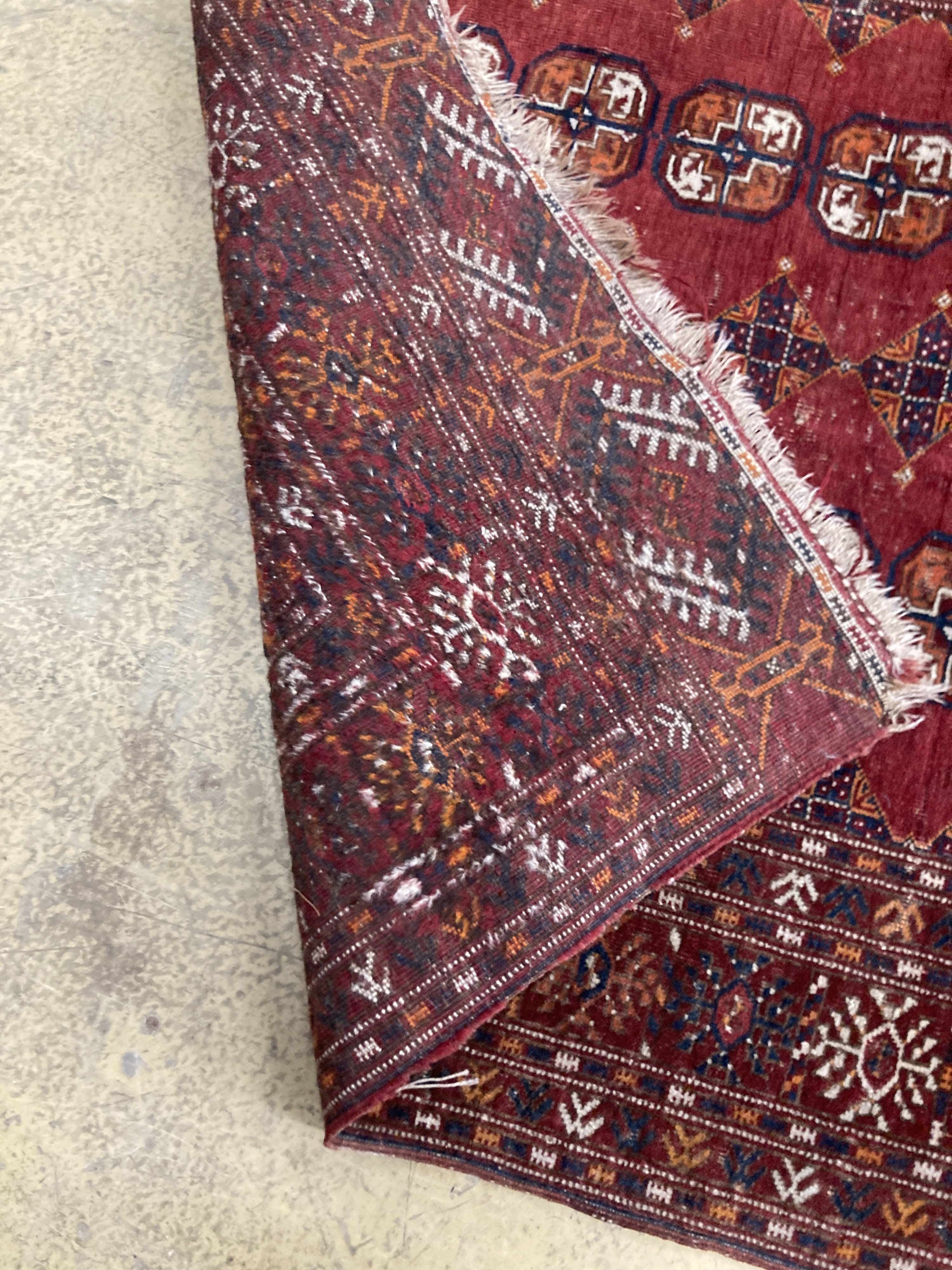 A Bokhara red ground rug, 190 x 114cm